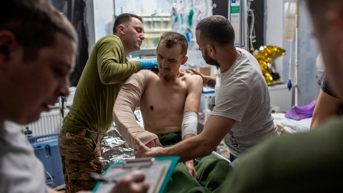 Military medics give first aid to a wounded Ukrainian soldier at a medical stabilisation point in the Dnipropetrovsk region of Ukraine