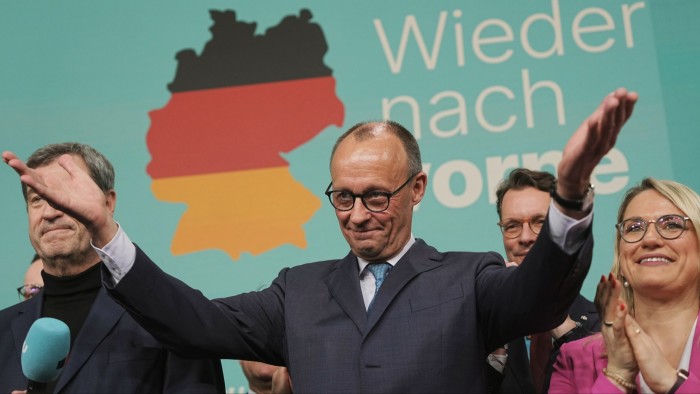 Friedrich Merz raising his hands