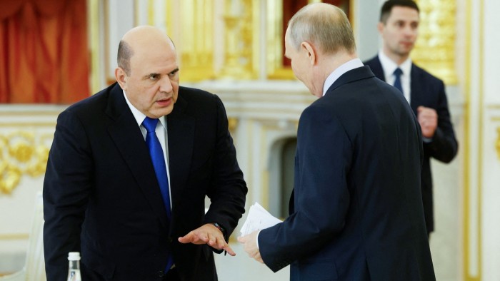 Vladimir Putin greets Russia Prime Minister Mikhail Mishustin