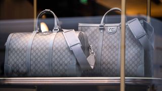Gray Ophidia duffle bags in Gucci storefront window