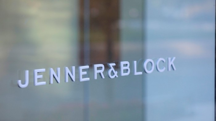 Signage for the law firm Jenner & Block is visible on a glass surface