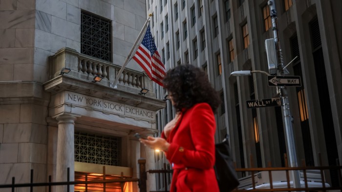 Person walks by the New York Stock Exchange