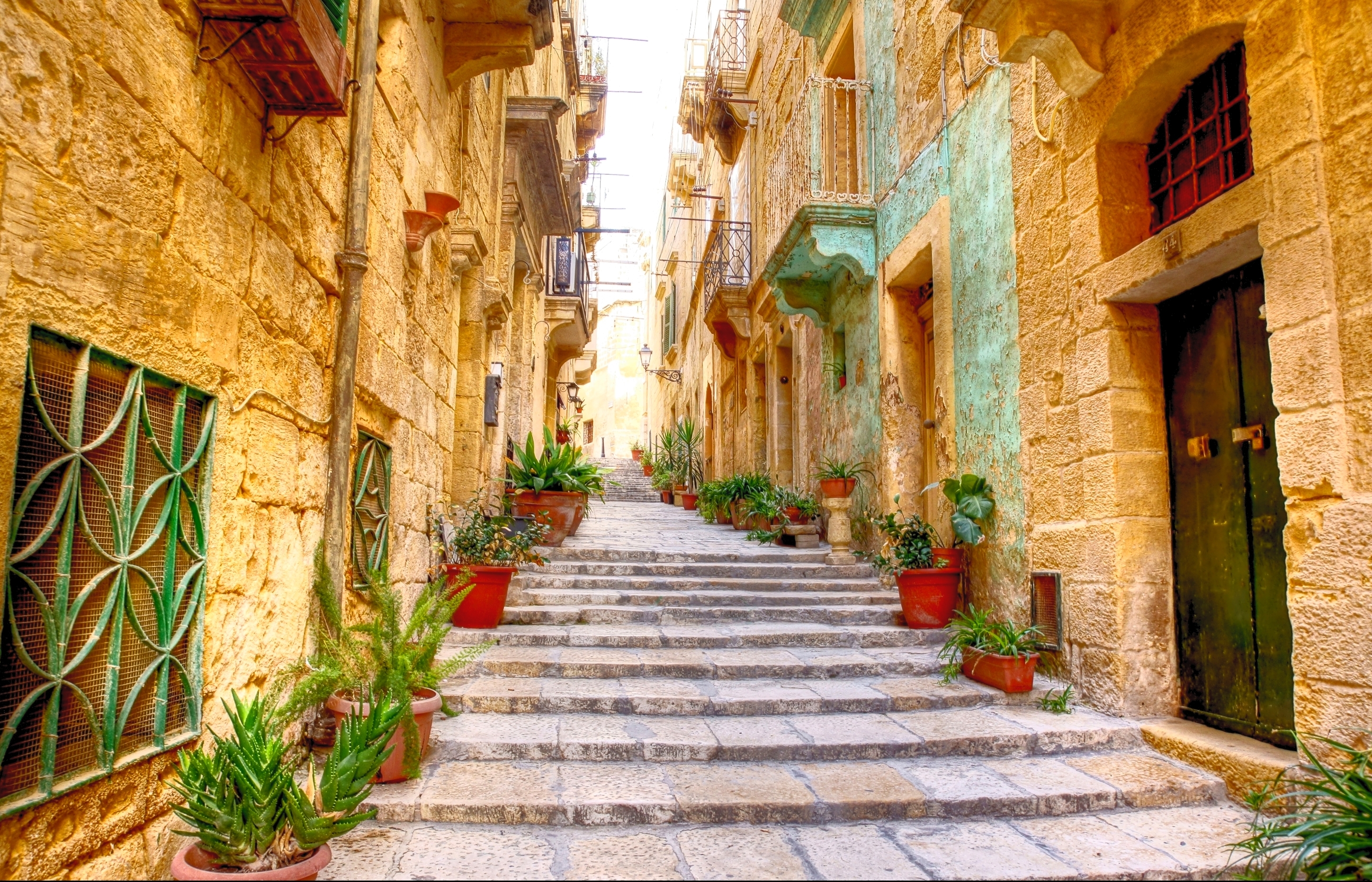 Typical narrow street with stairs in the city Valetta on the island of Malta.