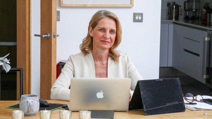Wera Hobhouse sits at a table working on a laptop