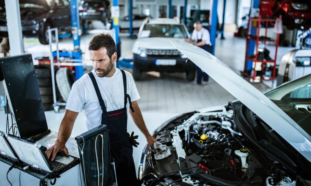 Person inspecting car engine