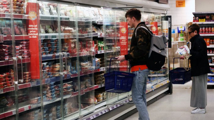 Customers shop at a Sainsbury’s supermarket