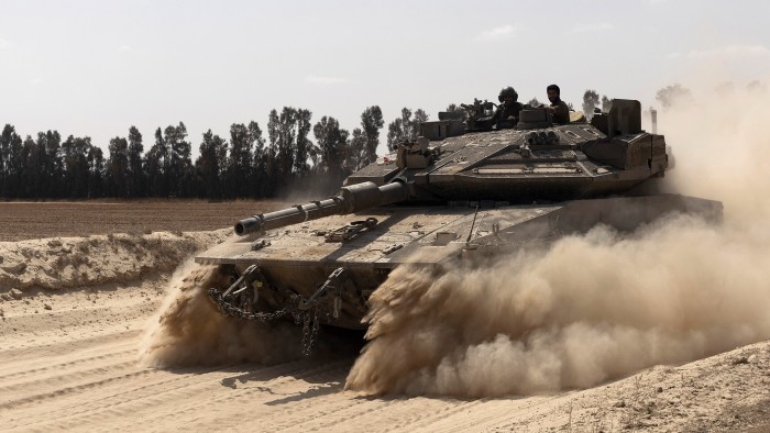 An Israeli tank moves near border with the Gaza Strip