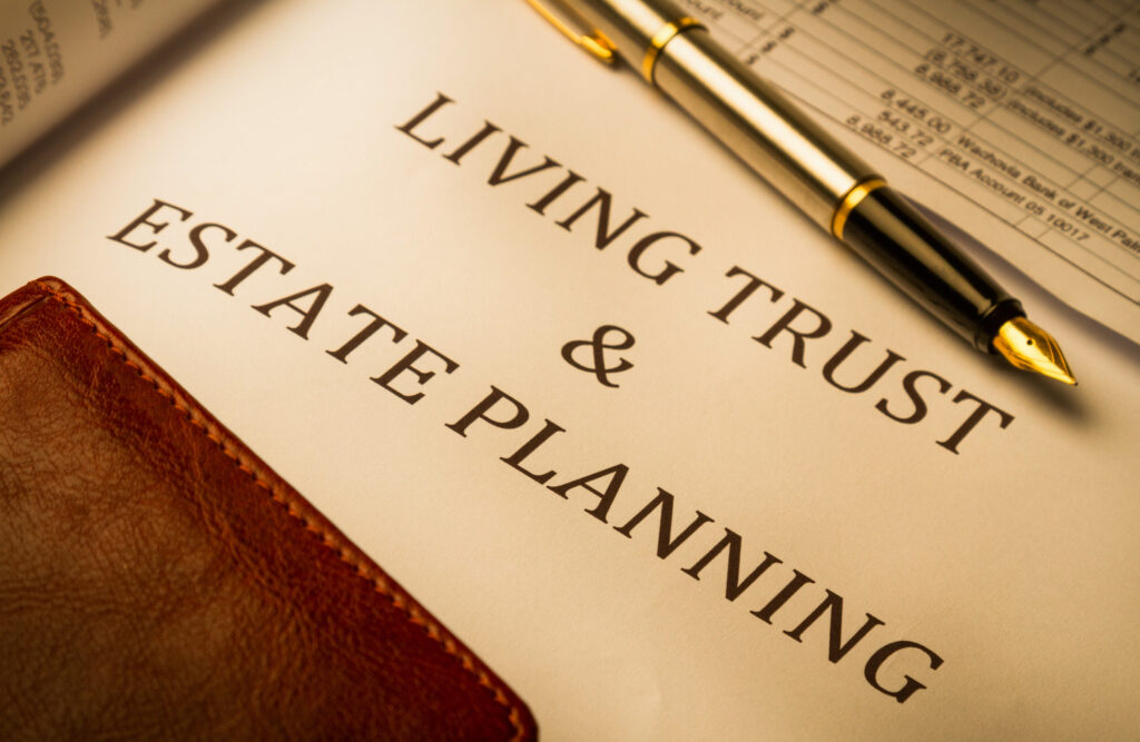 &quot;Living Trust and Estate Planning&quot; printed on paper, with fountain pen and leather book