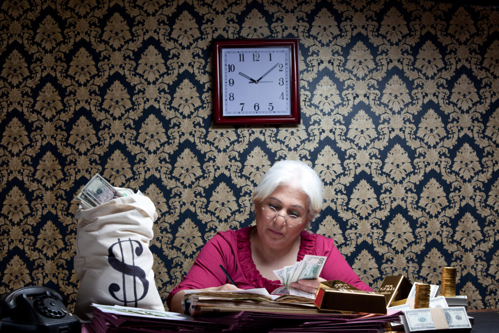 Woman sitting with a bag of cash