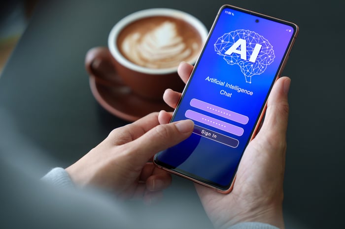 Person with phone using AI application.
