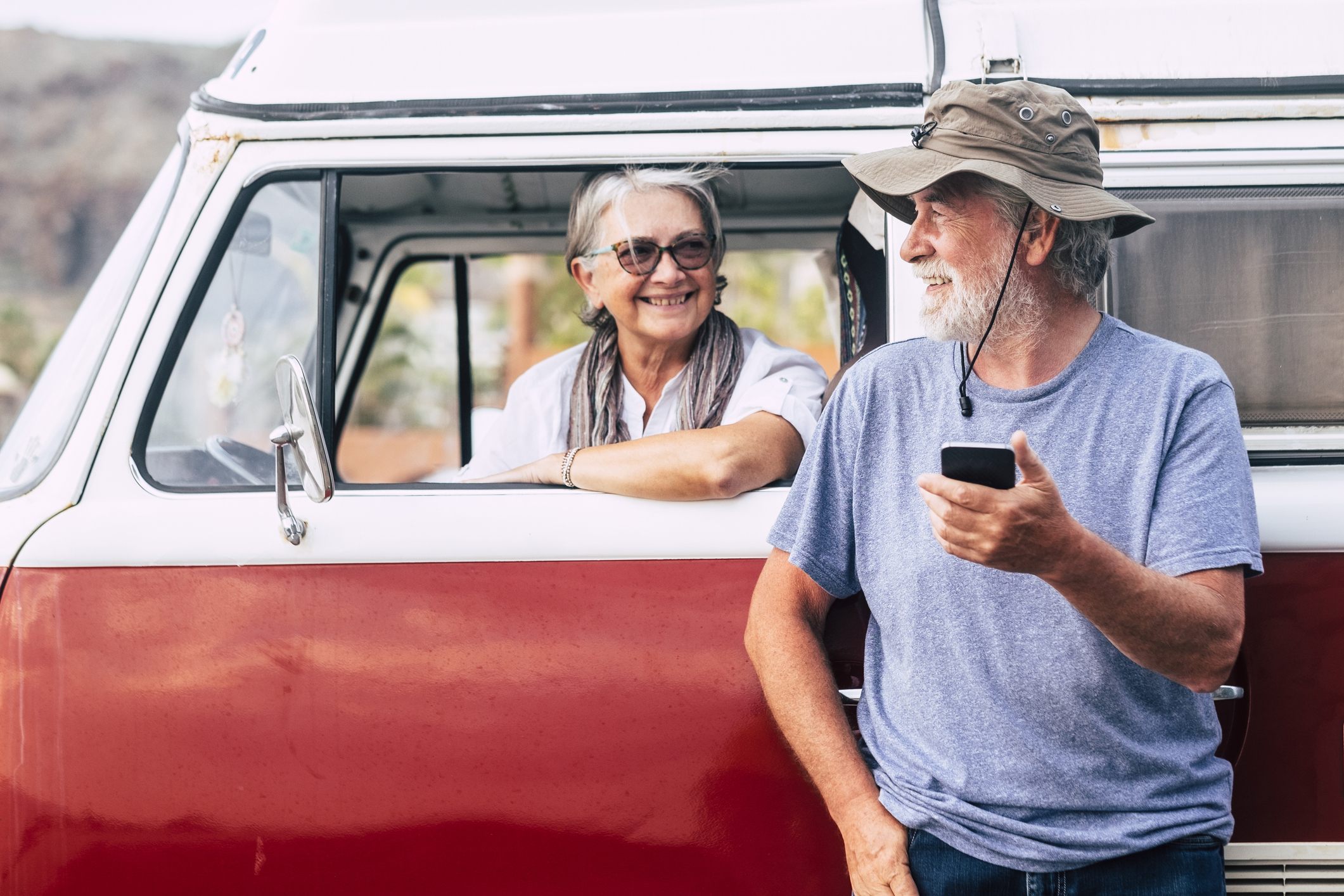 A senior couple in a van plans their summer road trip.