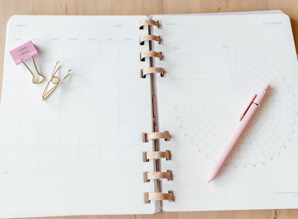 Journal on a desk with a clip that says