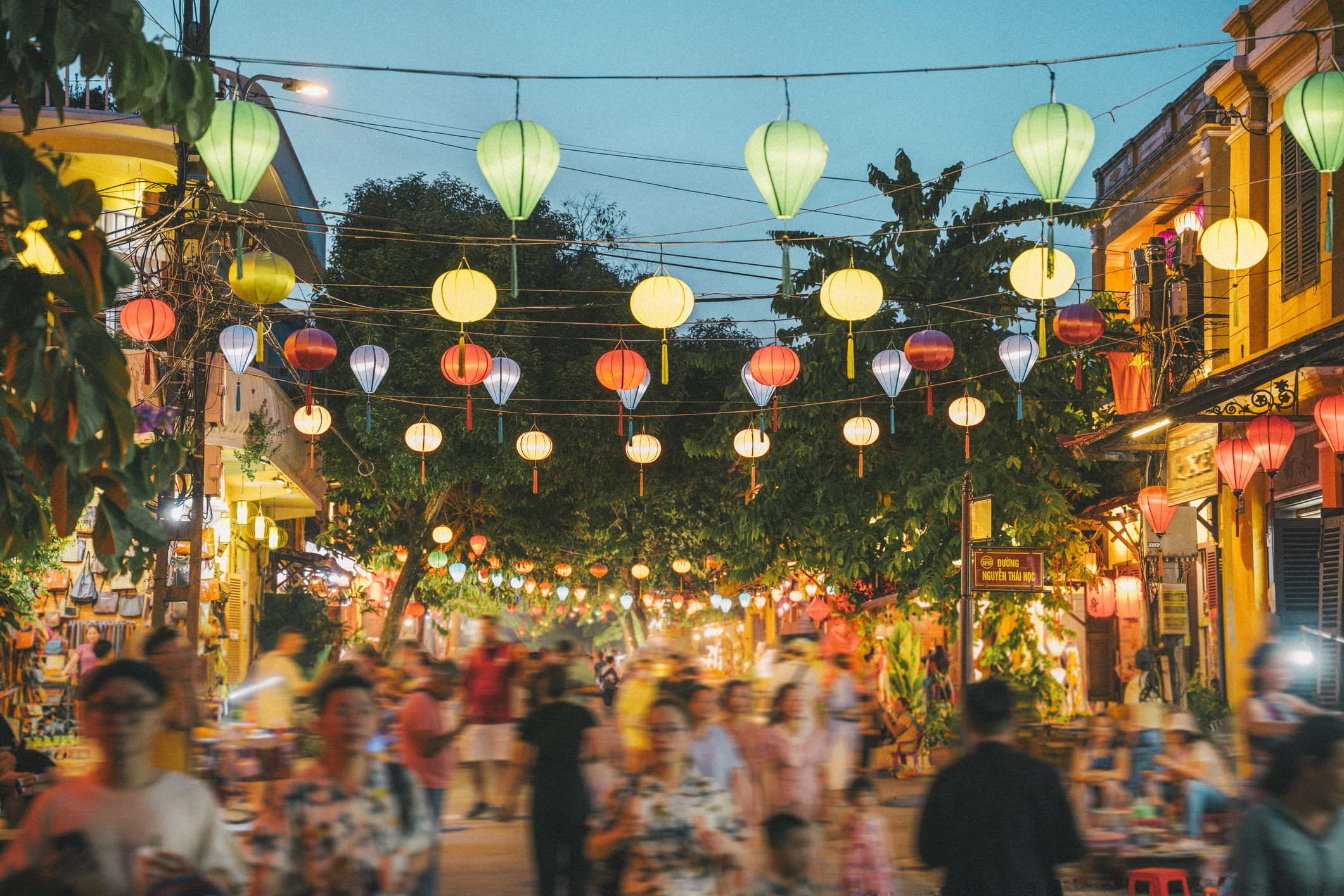 Hoi An, Vietnam at dusk, busy street - blurred people, decorative lanterns