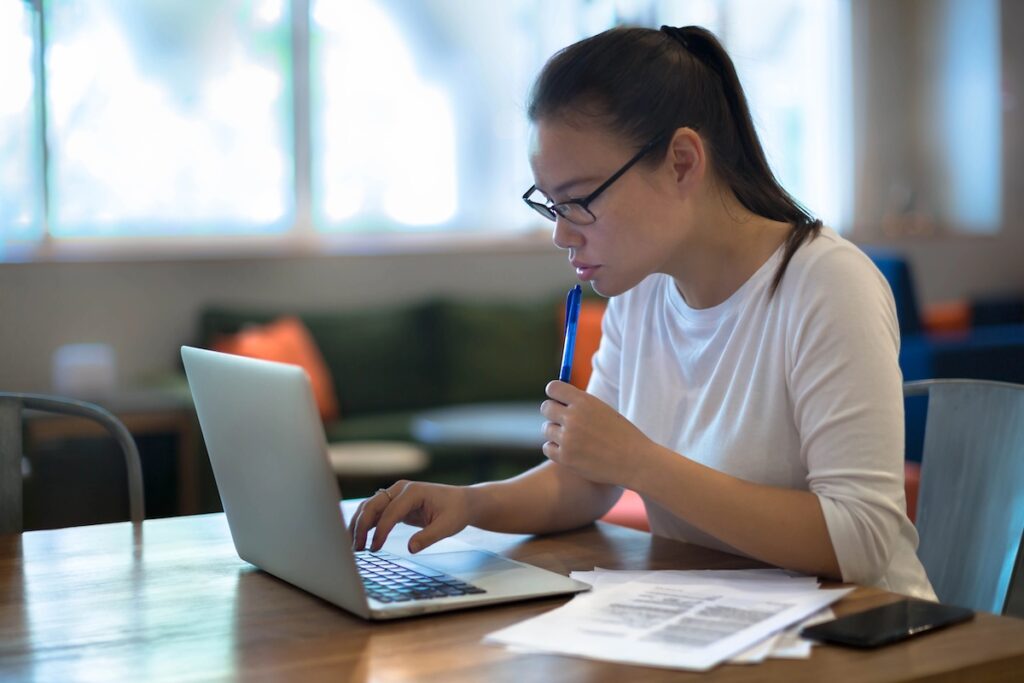 Woman working on private student loans | Source: The College Investor