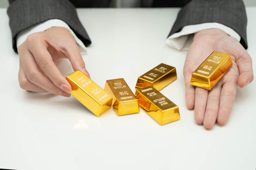 Hands presenting small gold bars