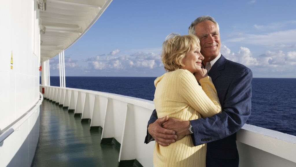 A mature couple hugging on a cruise ship.
