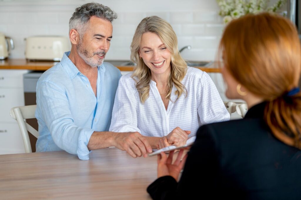 Three people looking at paperwork.