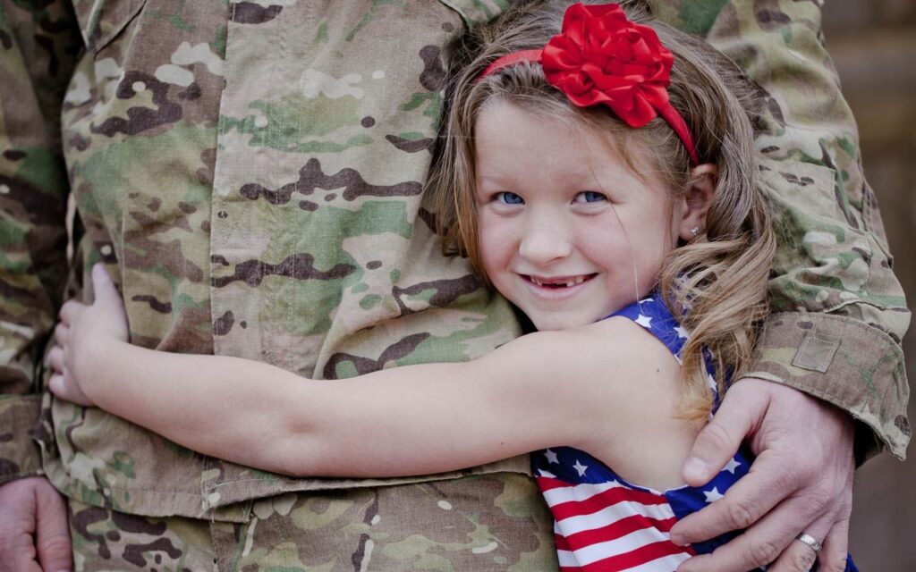 Child hugging a military service member.