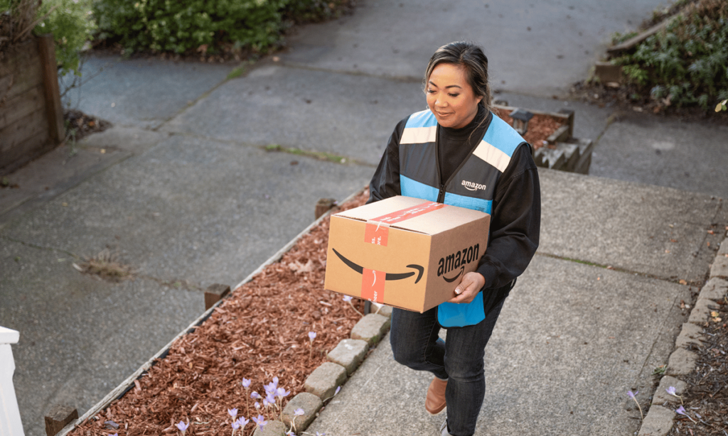 An Amazon worker holding a package.