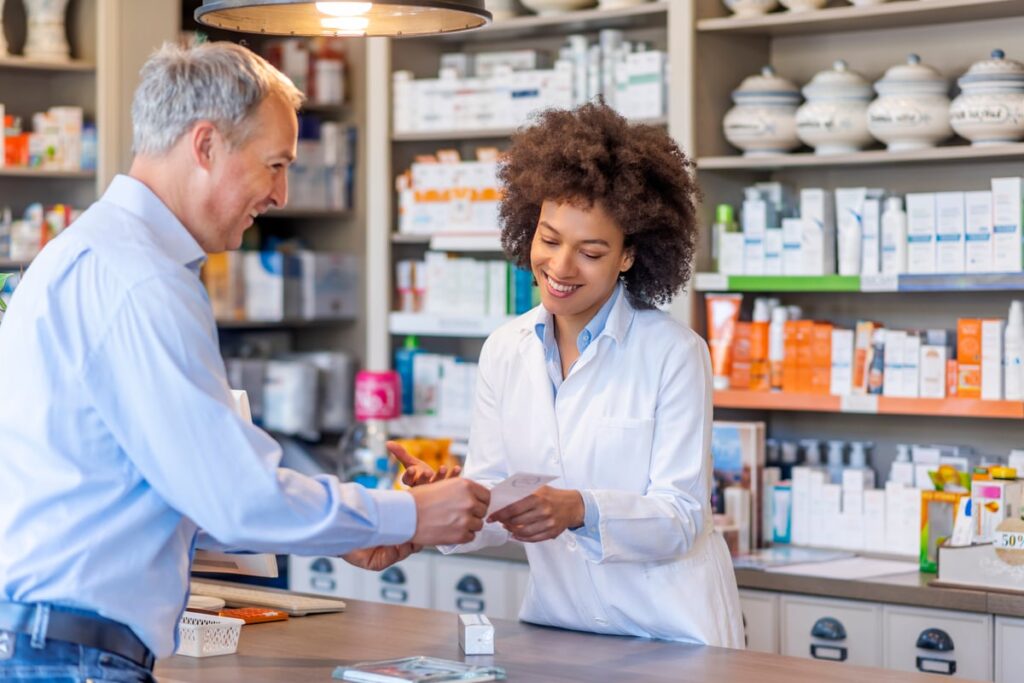 A pharmacist helping a customer with a medicine prescription.