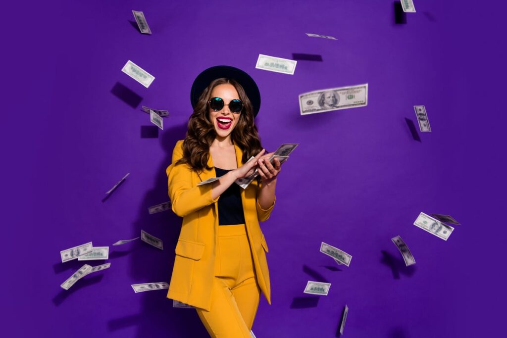 Person smiling as cash rains down.