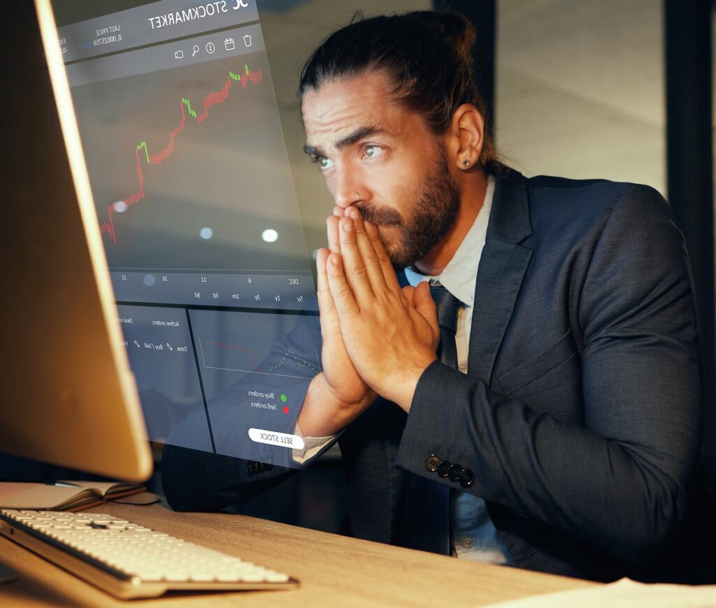 Professional looking at a computer screen with a concerned look on their face.