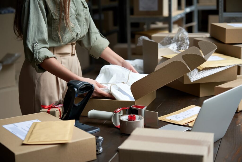 Person packing shipping boxes.