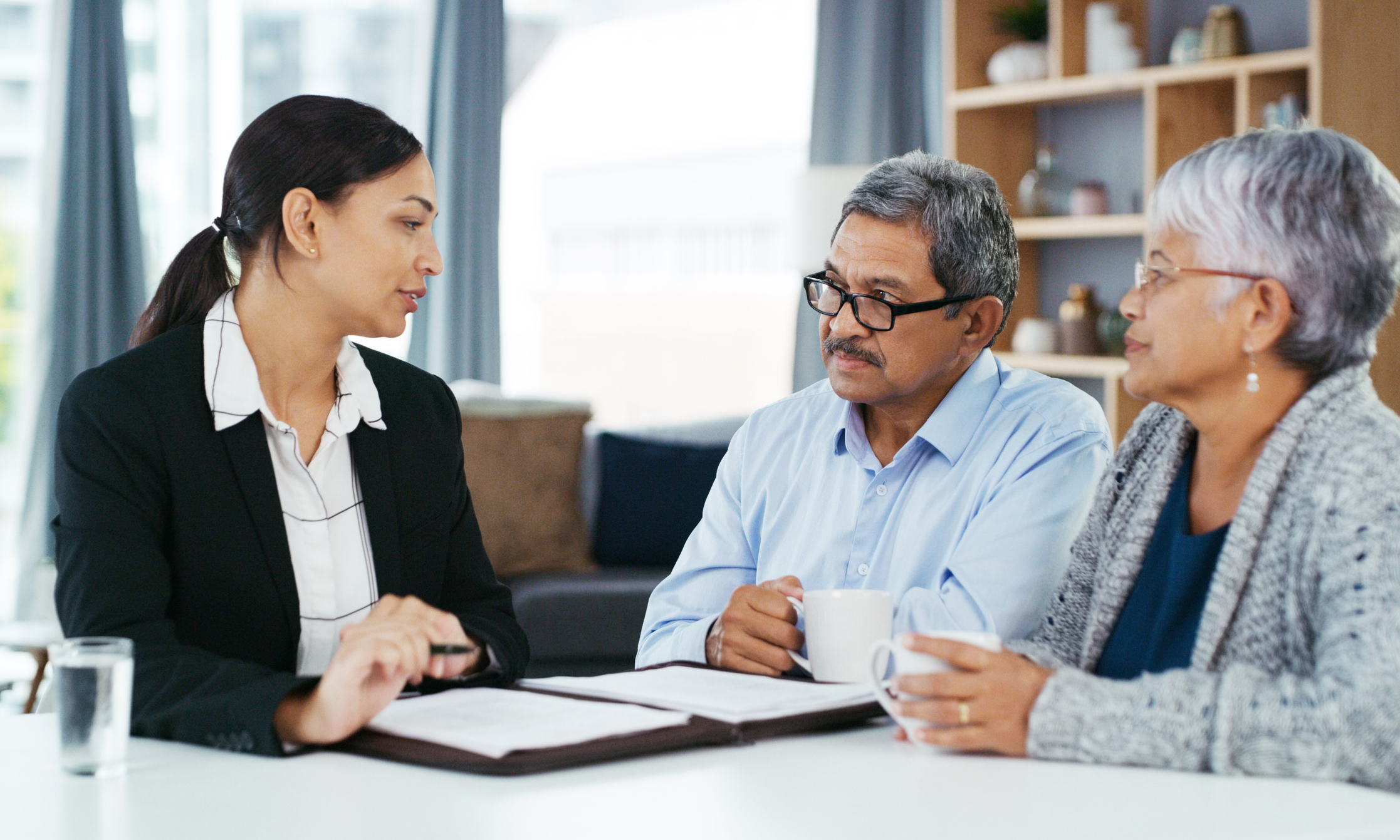 A couple discussing their home insurance options with their insurance broker