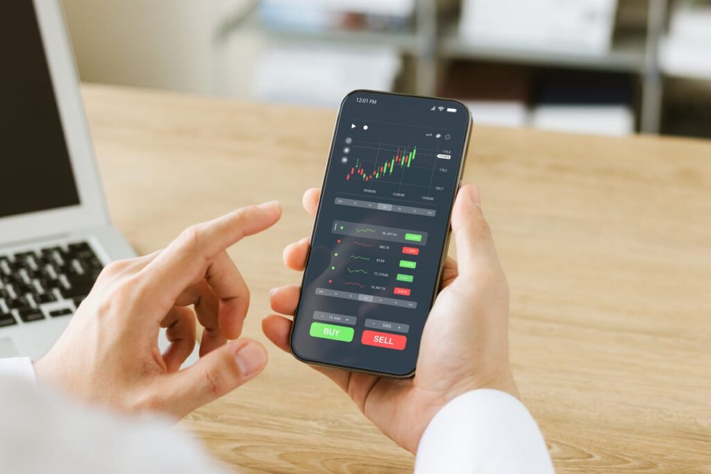 Person making a trade on a smartphone app.