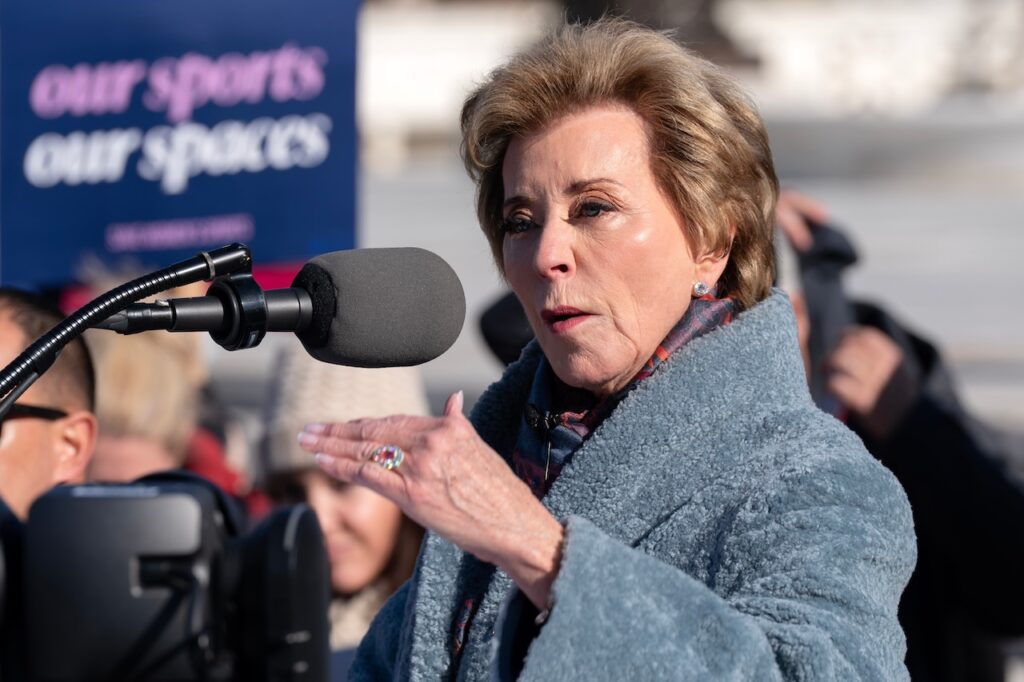 Education Secretary Linda McMahon speaks to the crowd as protesters gather outside the Supreme Court as it hears arguments over state laws barring transgender girls and women from playing on school athletic teams, Tuesday, Jan. 13, 2026, in Washington. (AP Photo/Jose Luis Magana)