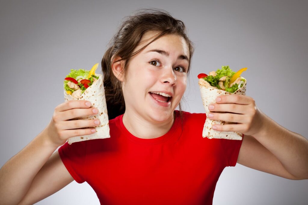 A young lady with her burrito.