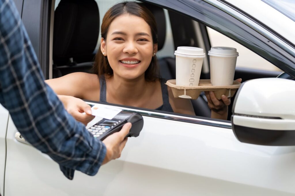 Person buying coffee through drive-thru.