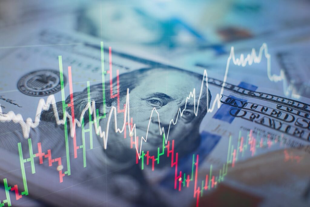 Volatile stock charts with money in the background.