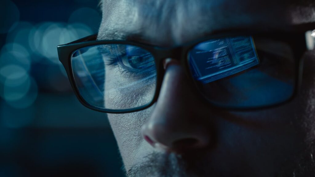 AI software is reflected in a person's eyeglasses.