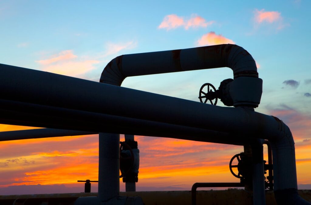 A looping pipeline with the sun setting in the background.