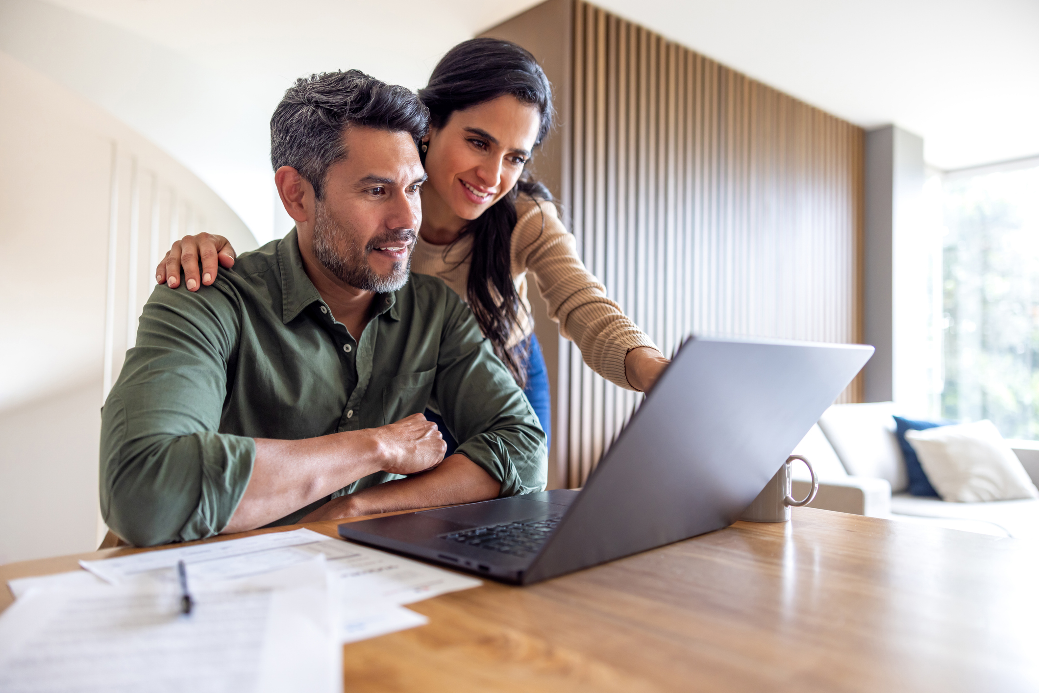 A couple looking at the savings account online.