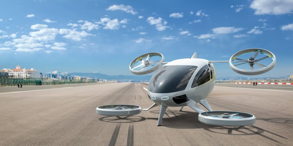An electric vertical takeoff and landing (eVTOL) aircraft sits on the tarmac.