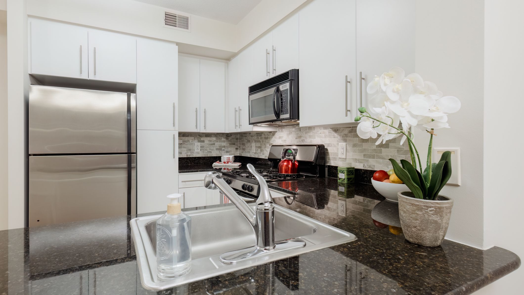 Kitchen With White Cabinets and Stainless Steel Appliances