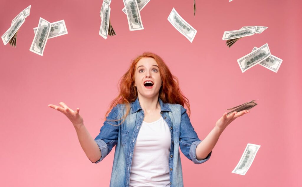 Someone surprised to see money falling from above.
