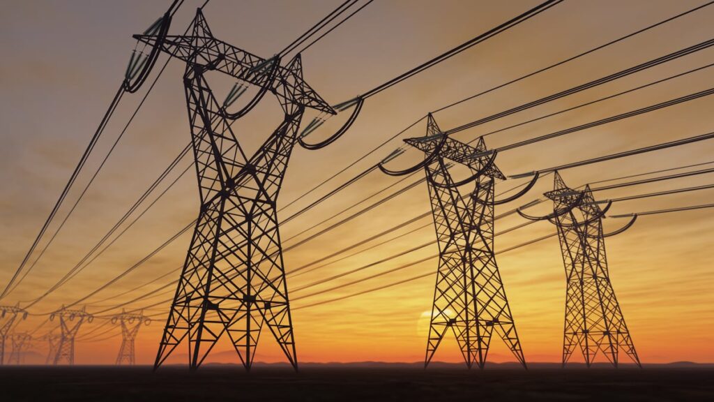 Power transmission lines against the backdrop of a setting sun.