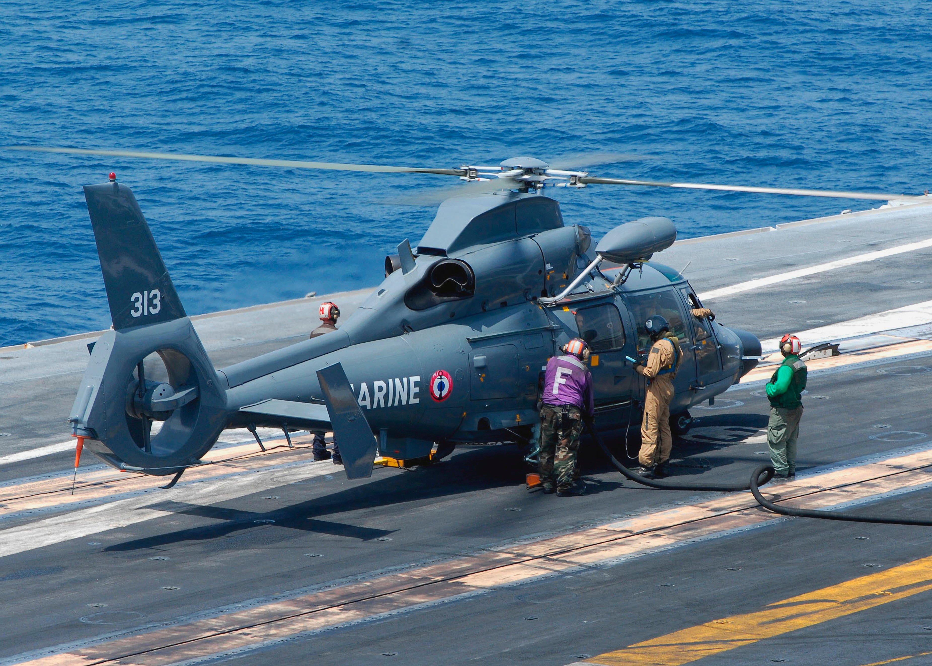 A helicopter on an aircraft carrier. 