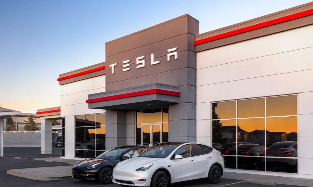 Tesla dealership with two cars parked in front of the building.