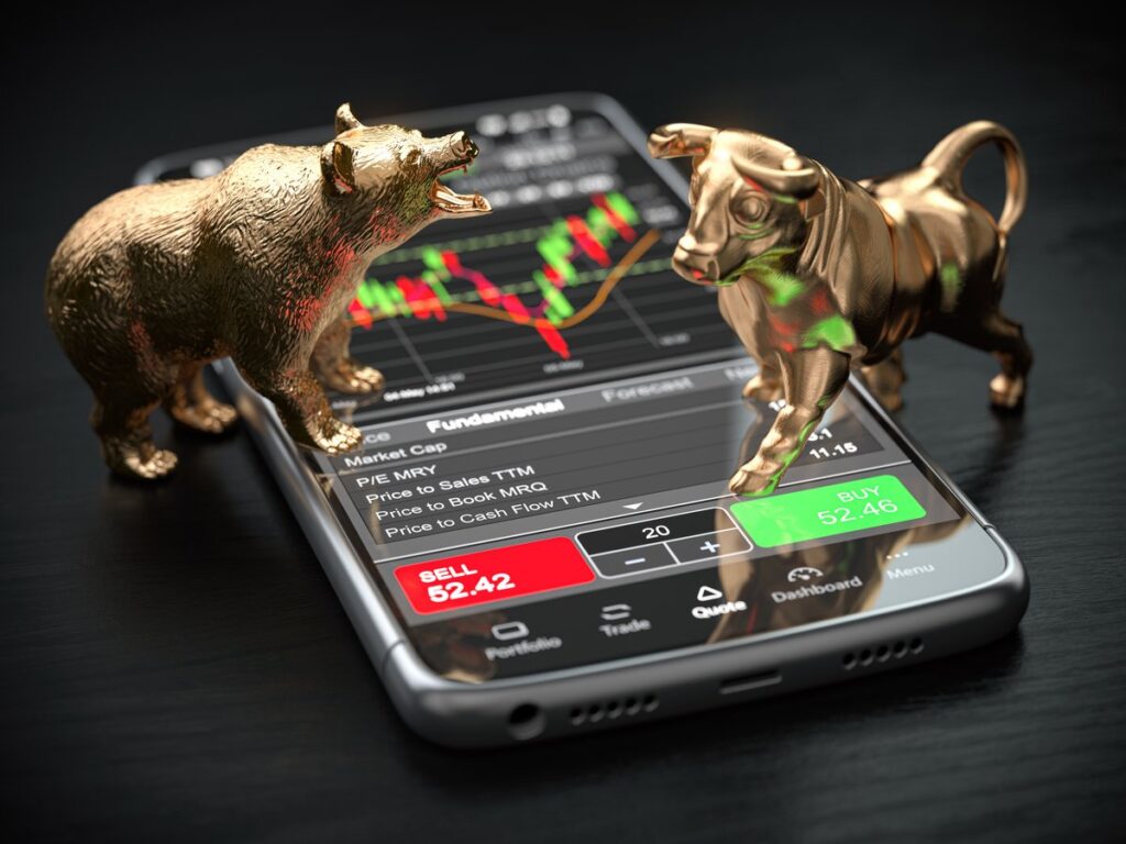 Bull and bear statues trading stocks on a phone.
