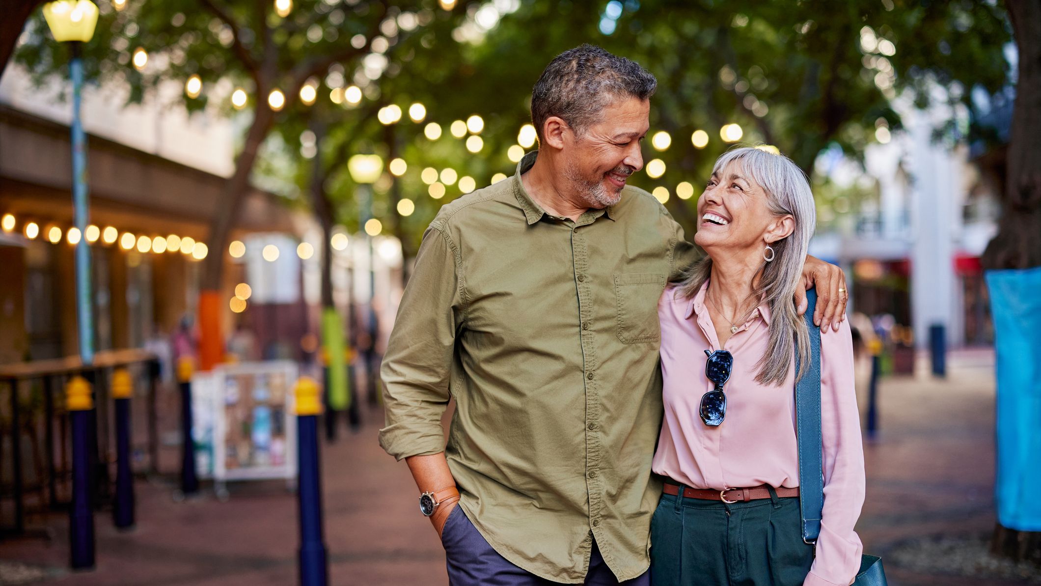 A happy, mature couple enjoys a romantic evening outdoors.