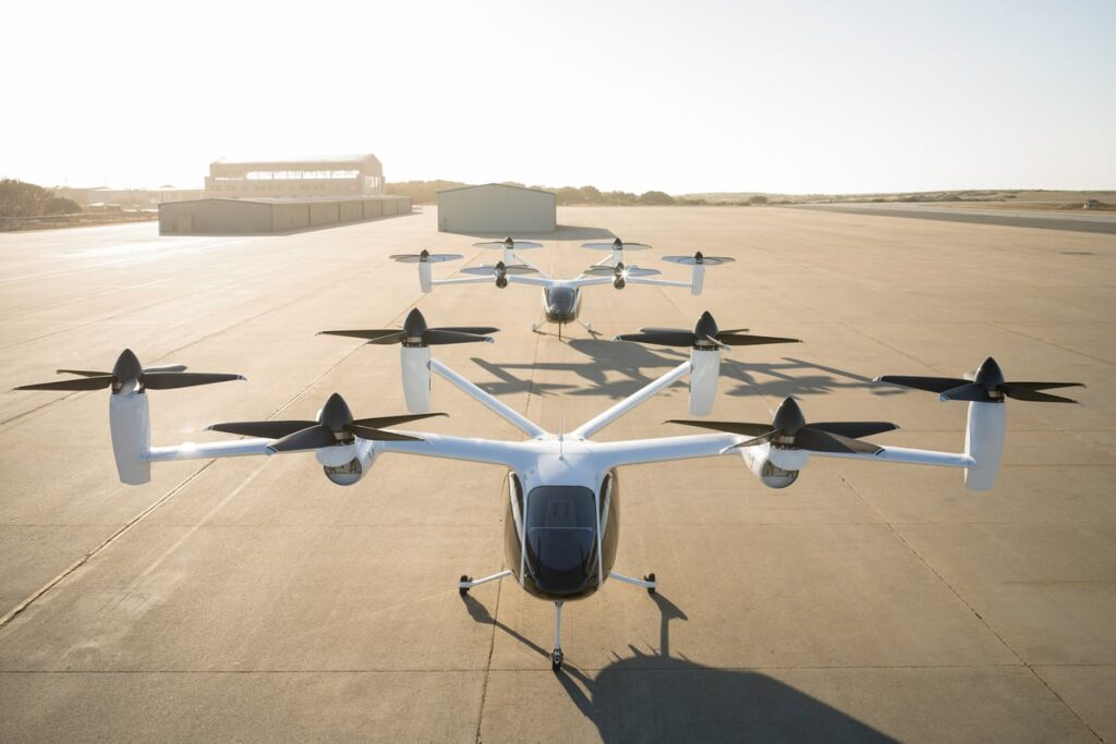 Two Joby aircraft idling on a runway.