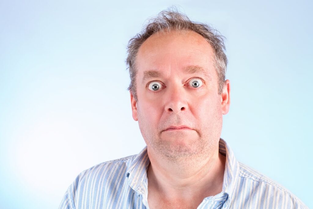 Someone in a collared shirt is looking very startled.
