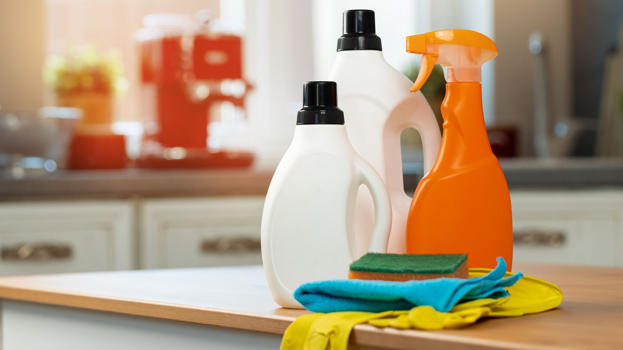 Cleaning detergents and tools on a kitchen counter