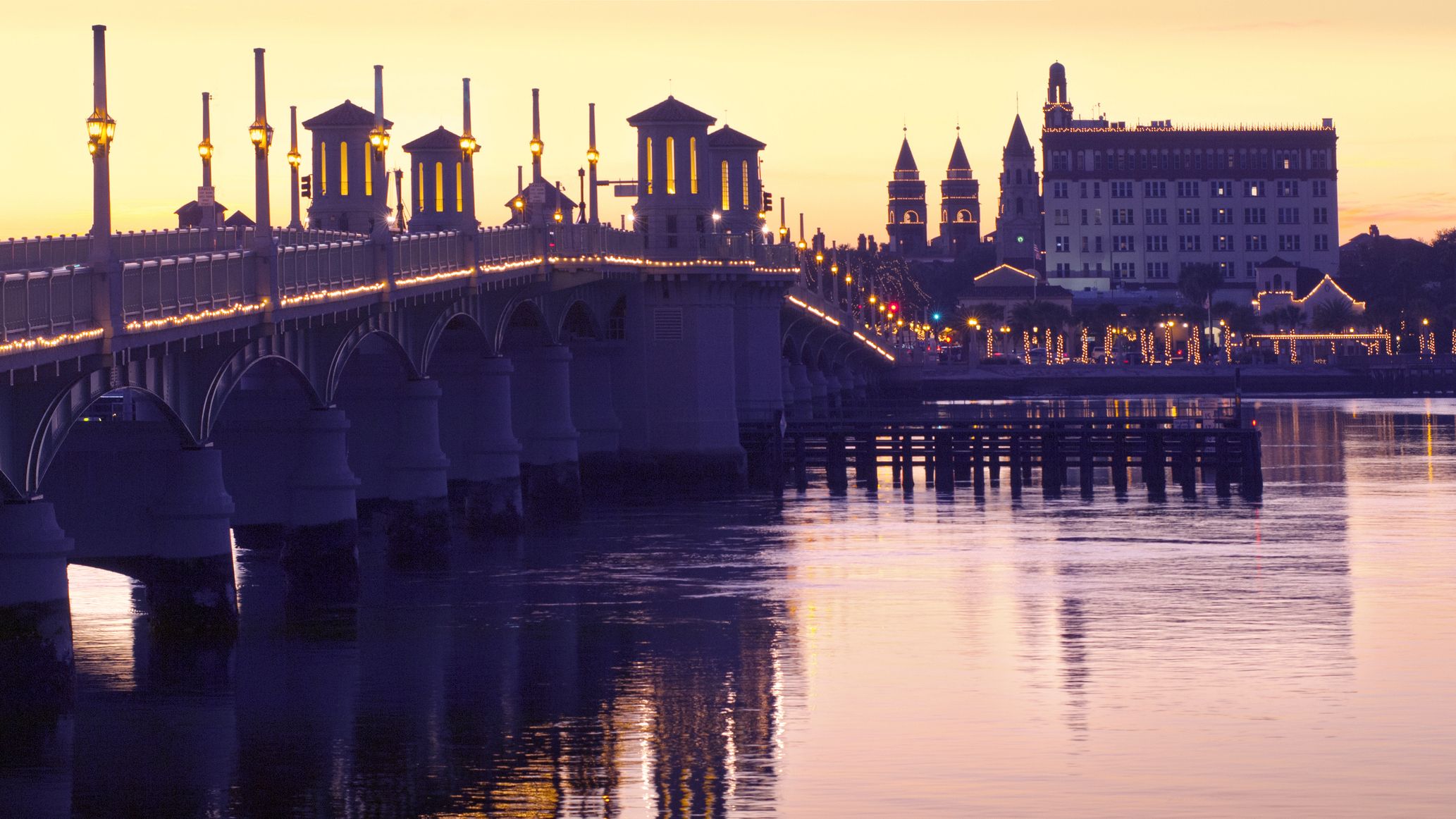The Bridge of Lions illuminated tower piers stand over the Matanzas River between downtown Saint Augustine, Florida.
