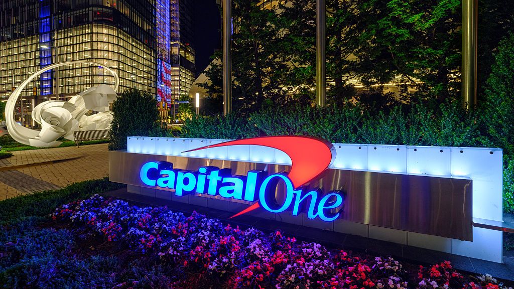The Capital One logo is lit up outside of the financial services company headquarters building at night on June 7, 2025, in Tysons, VA.