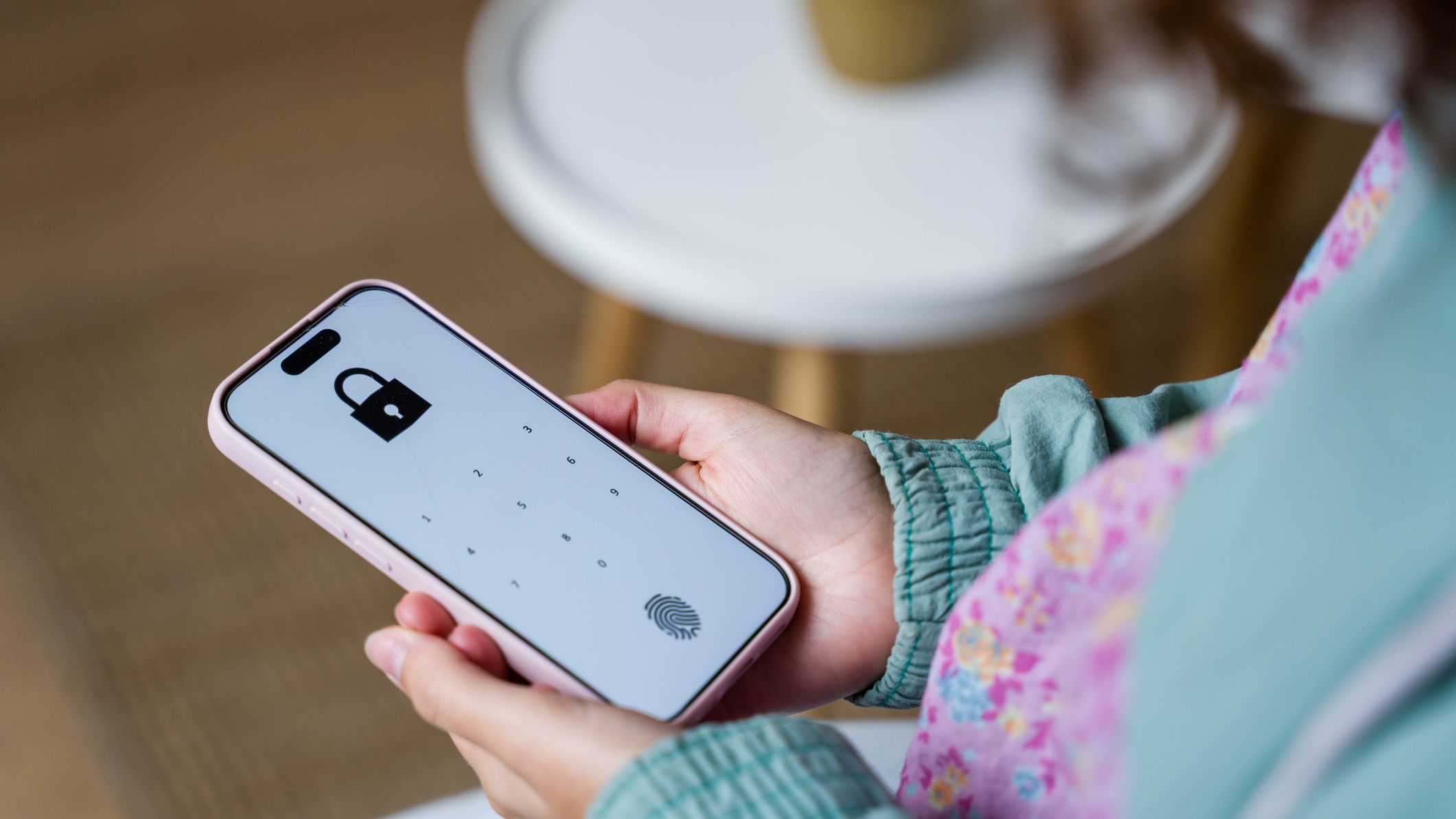 a woman uses a PIN code to unlock a phone app similar to the experience you have with Cash App
